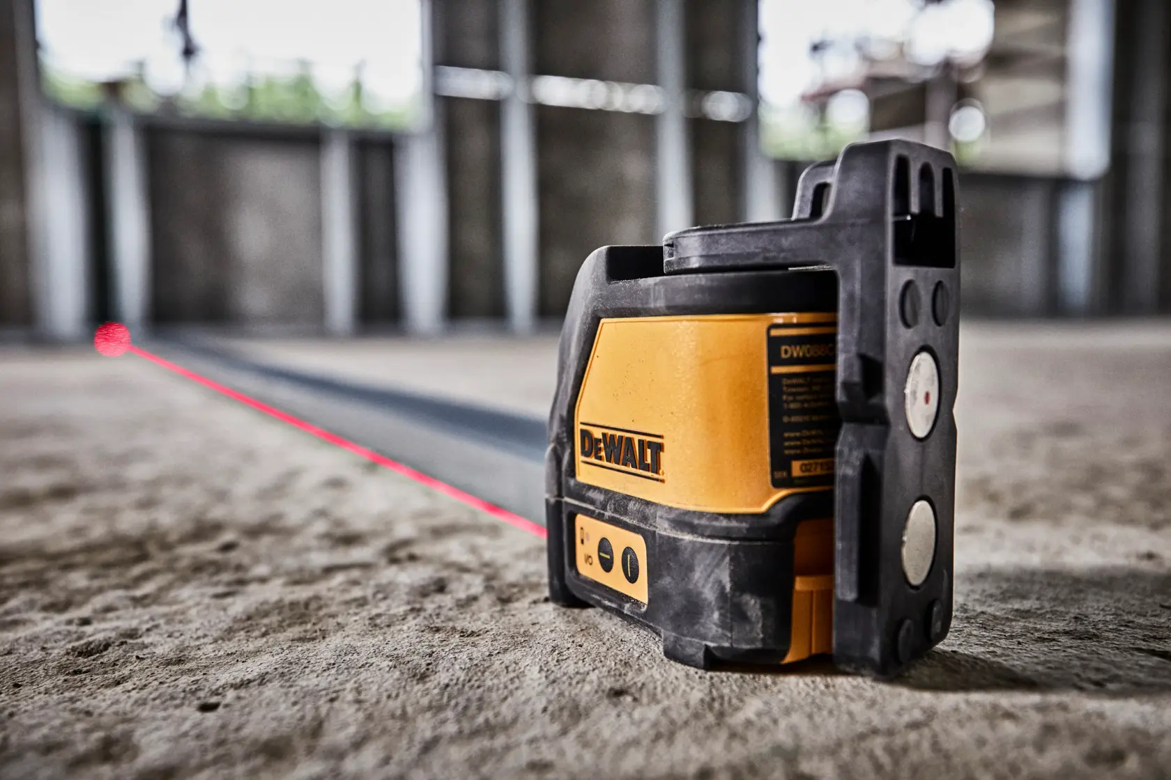 Nivel láser DEWALT DW088K proyecta una línea roja en el suelo para una alineación precisa.